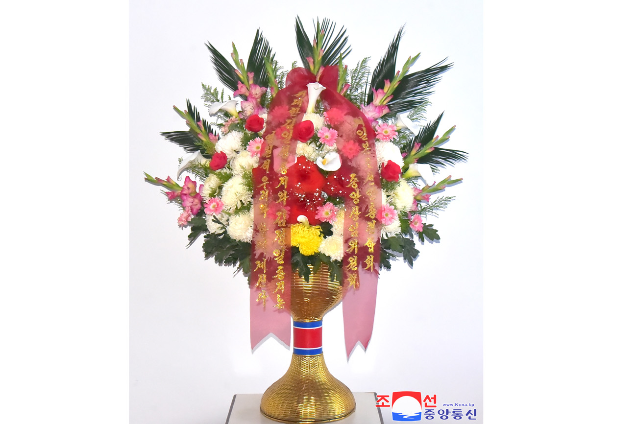Floral tribute paid to bronze statues of great leaders Kim Il Sung and Kim Jong Il