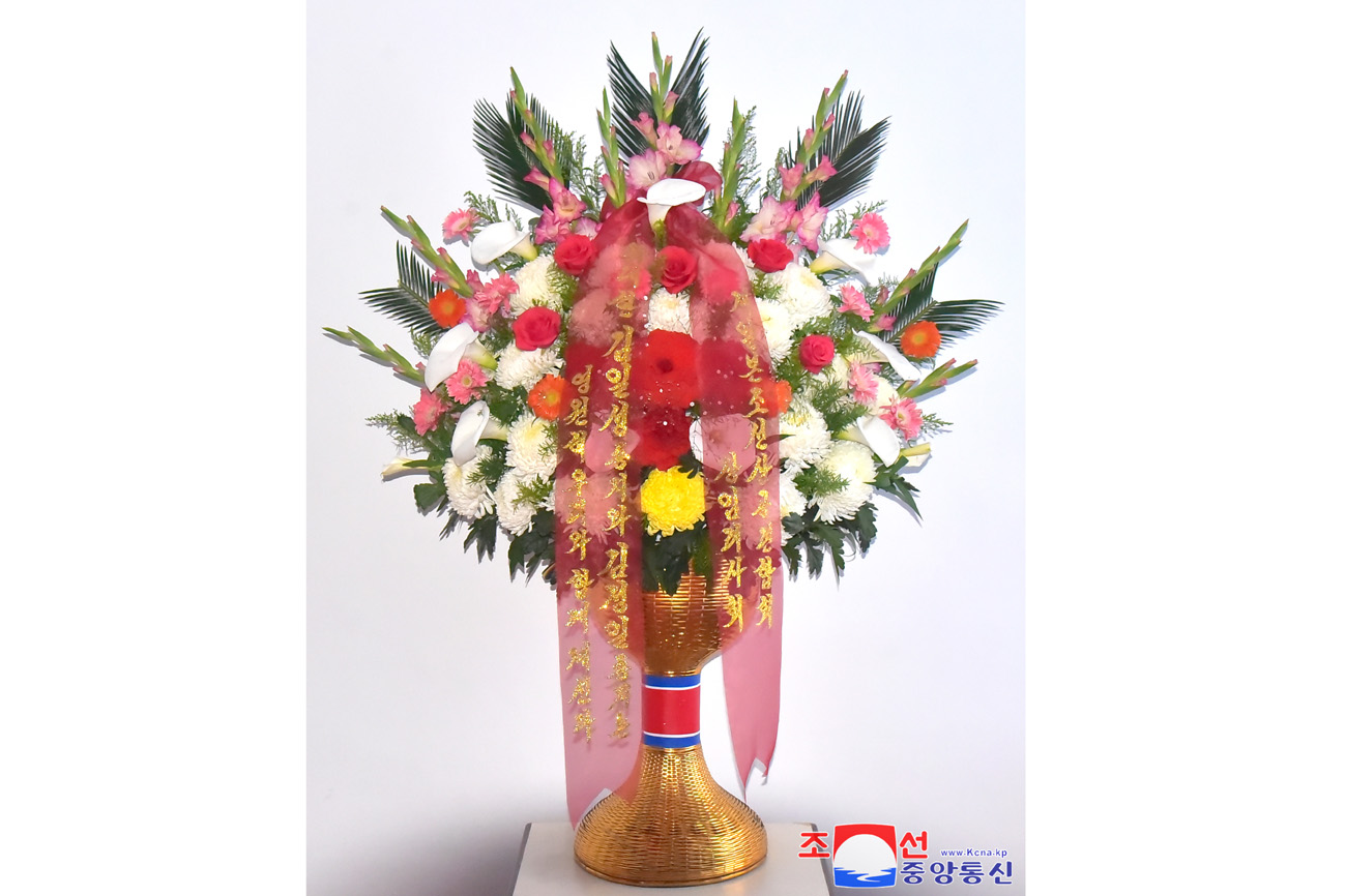 Floral tribute paid to bronze statues of great leaders Kim Il Sung and Kim Jong Il