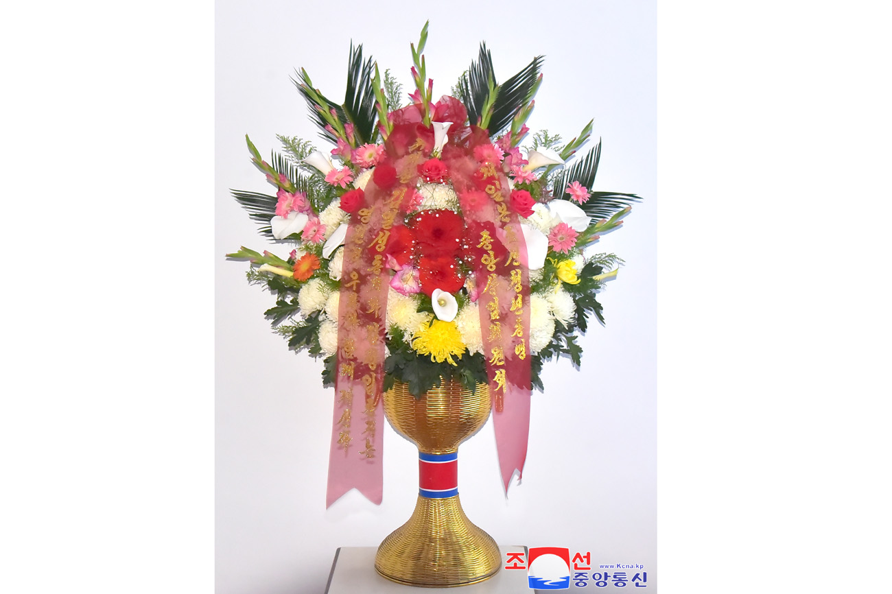 Floral tribute paid to bronze statues of great leaders Kim Il Sung and Kim Jong Il
