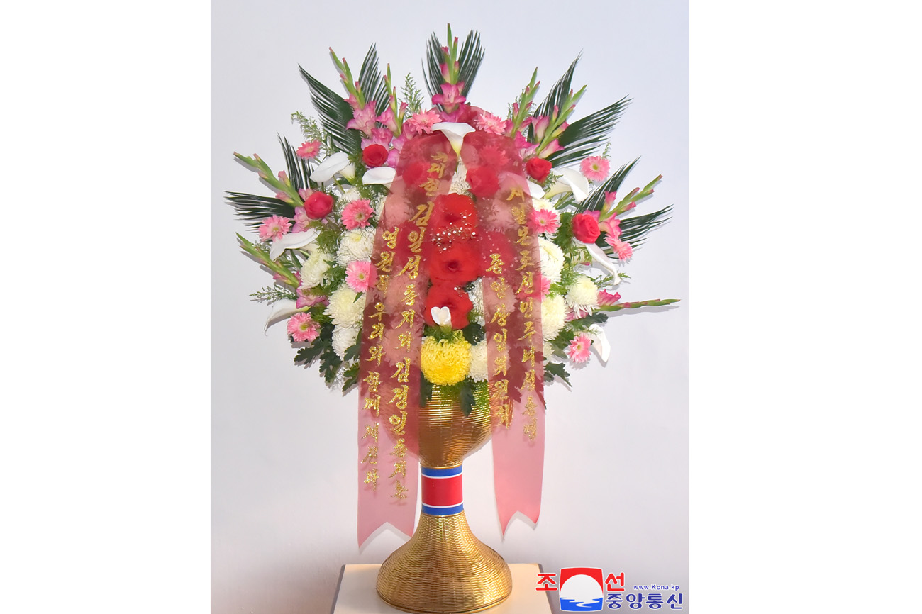 Floral tribute paid to bronze statues of great leaders Kim Il Sung and Kim Jong Il