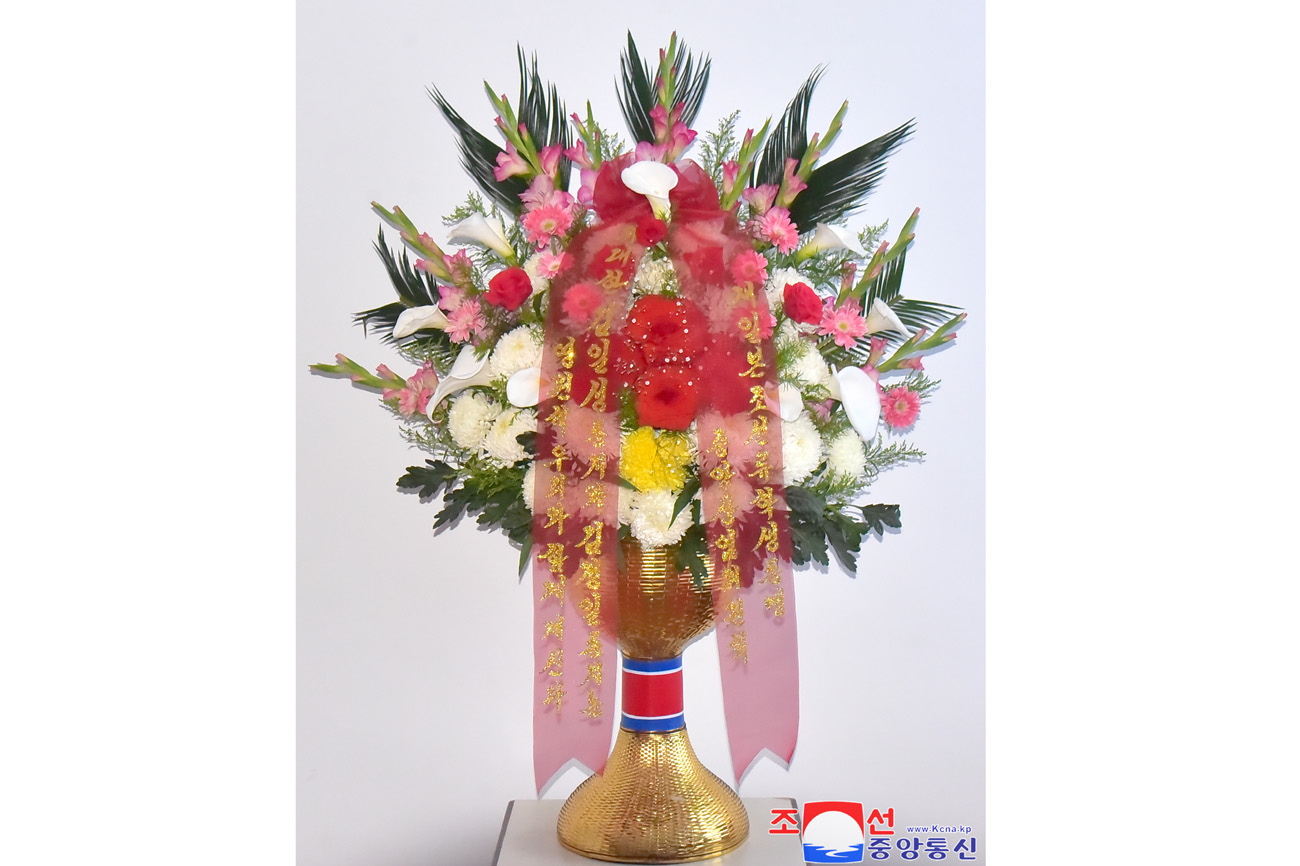 Floral tribute paid to bronze statues of great leaders Kim Il Sung and Kim Jong Il