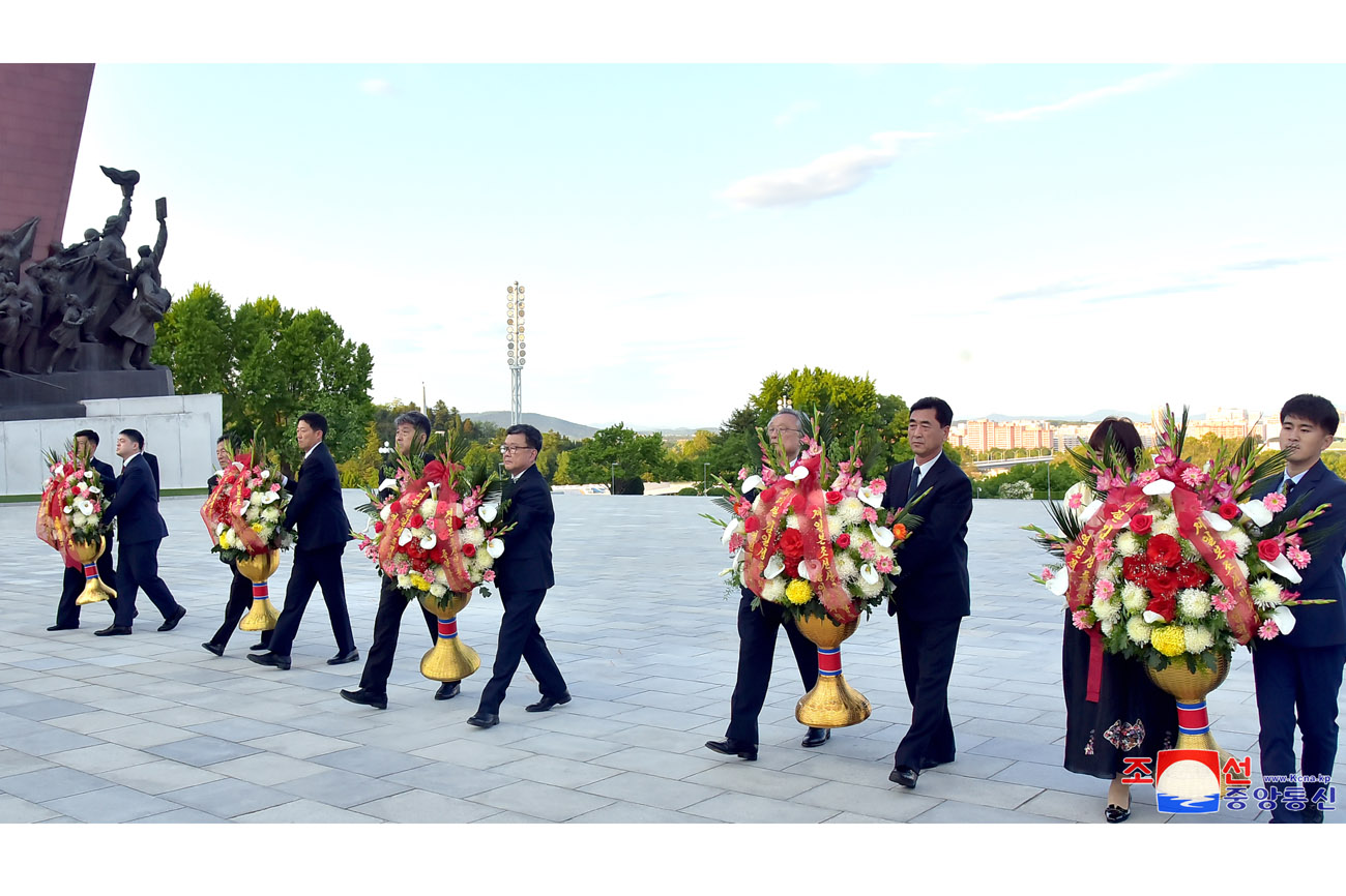 Floral tribute paid to bronze statues of great leaders Kim Il Sung and Kim Jong Il