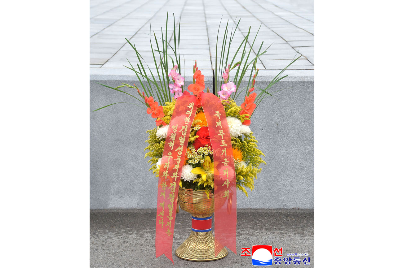 Floral baskets sent to bronze statues of great leaders Kim Il Sung and Kim Jong Il