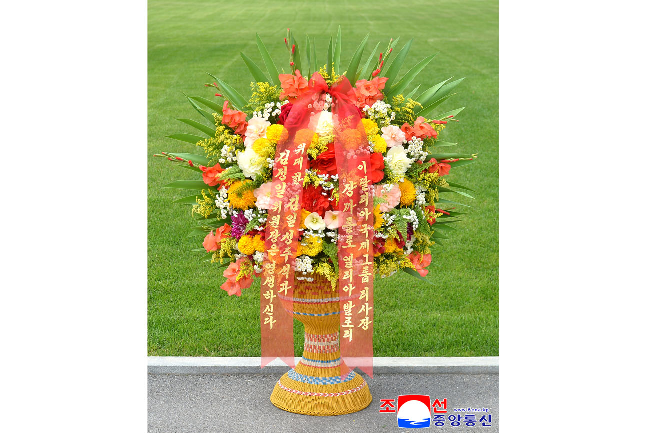 Floral baskets sent to bronze statues of great leaders Kim Il Sung and Kim Jong Il