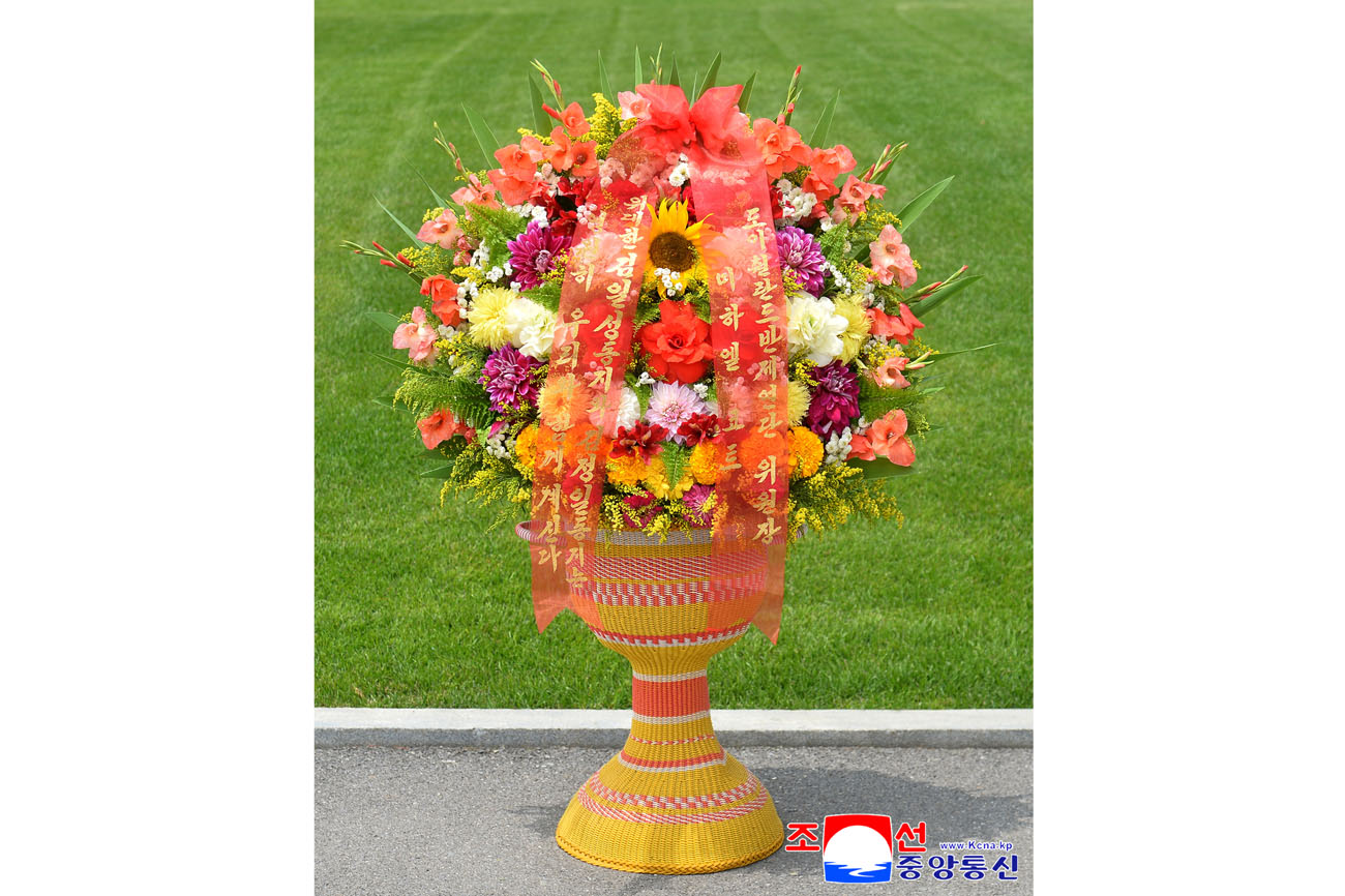 Floral baskets sent to bronze statues of great leaders Kim Il Sung and Kim Jong Il