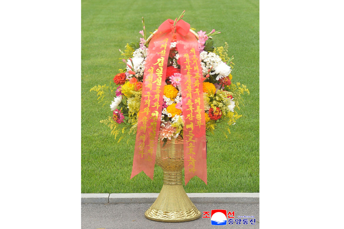 Floral baskets sent to bronze statues of great leaders Kim Il Sung and Kim Jong Il