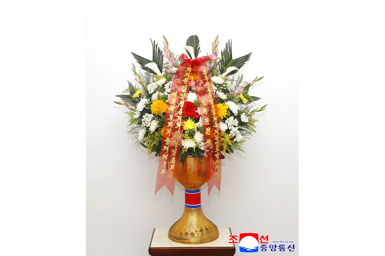 Floral baskets sent to bronze statues of great leaders Kim Il Sung and Kim Jong Il