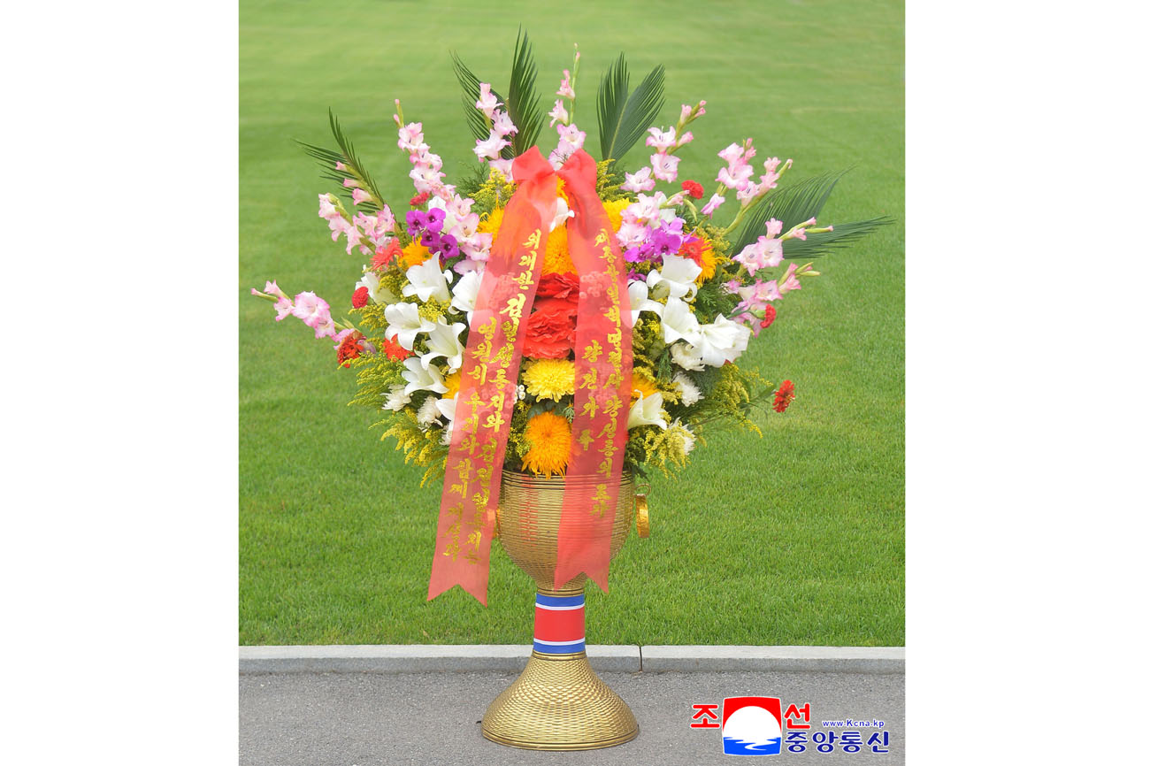 Floral baskets sent to bronze statues of great leaders Kim Il Sung and Kim Jong Il
