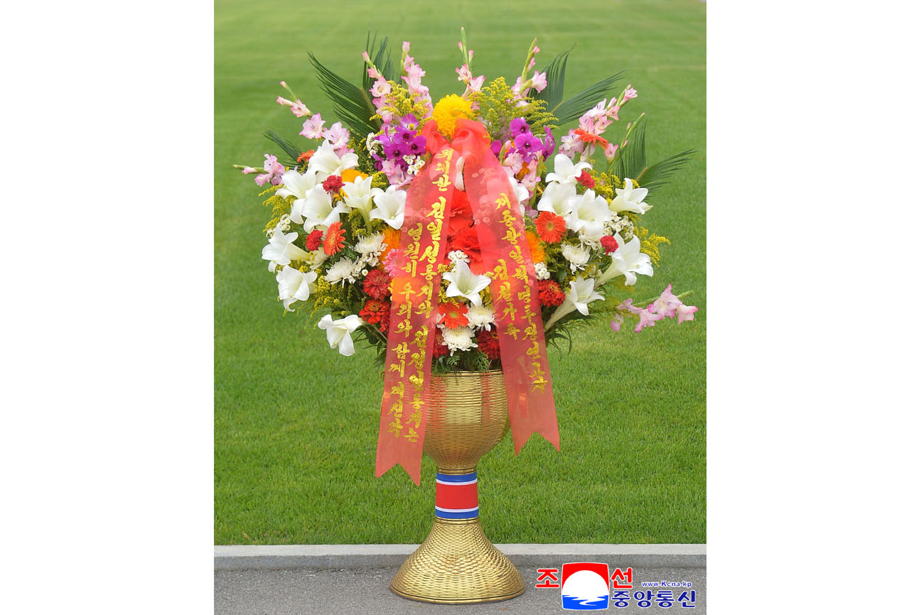 Floral baskets sent to bronze statues of great leaders Kim Il Sung and Kim Jong Il