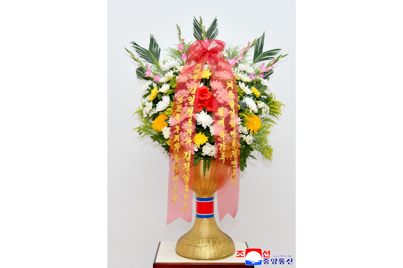 Floral baskets sent to bronze statues of great leaders Kim Il Sung and Kim Jong Il