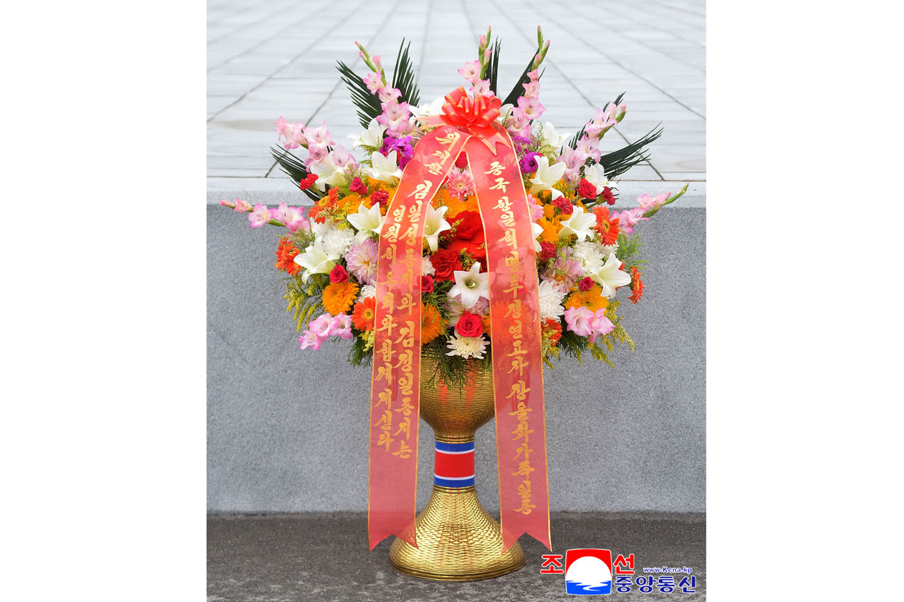 Floral baskets sent to bronze statues of great leaders Kim Il Sung and Kim Jong Il