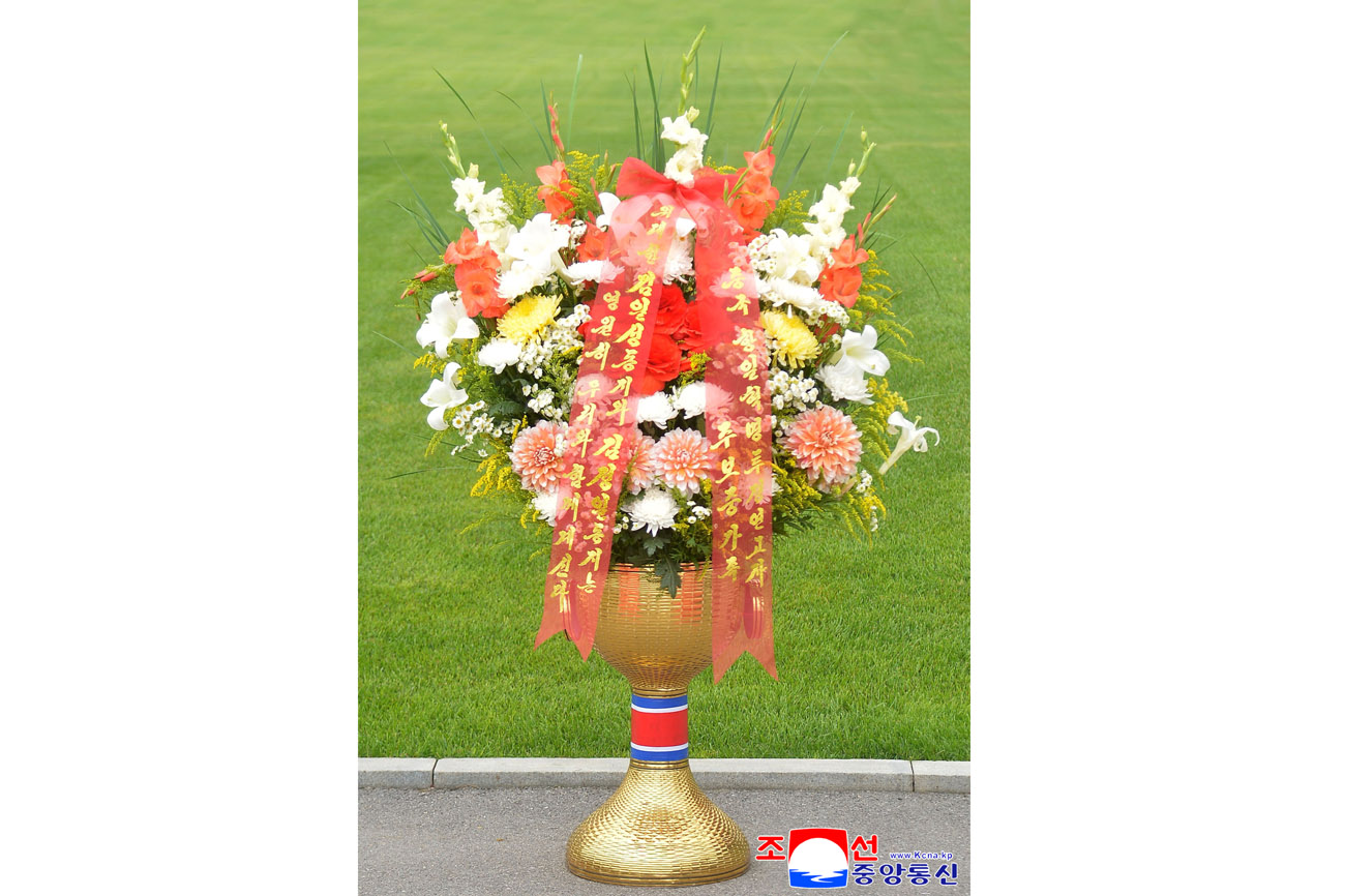 Floral baskets sent to bronze statues of great leaders Kim Il Sung and Kim Jong Il