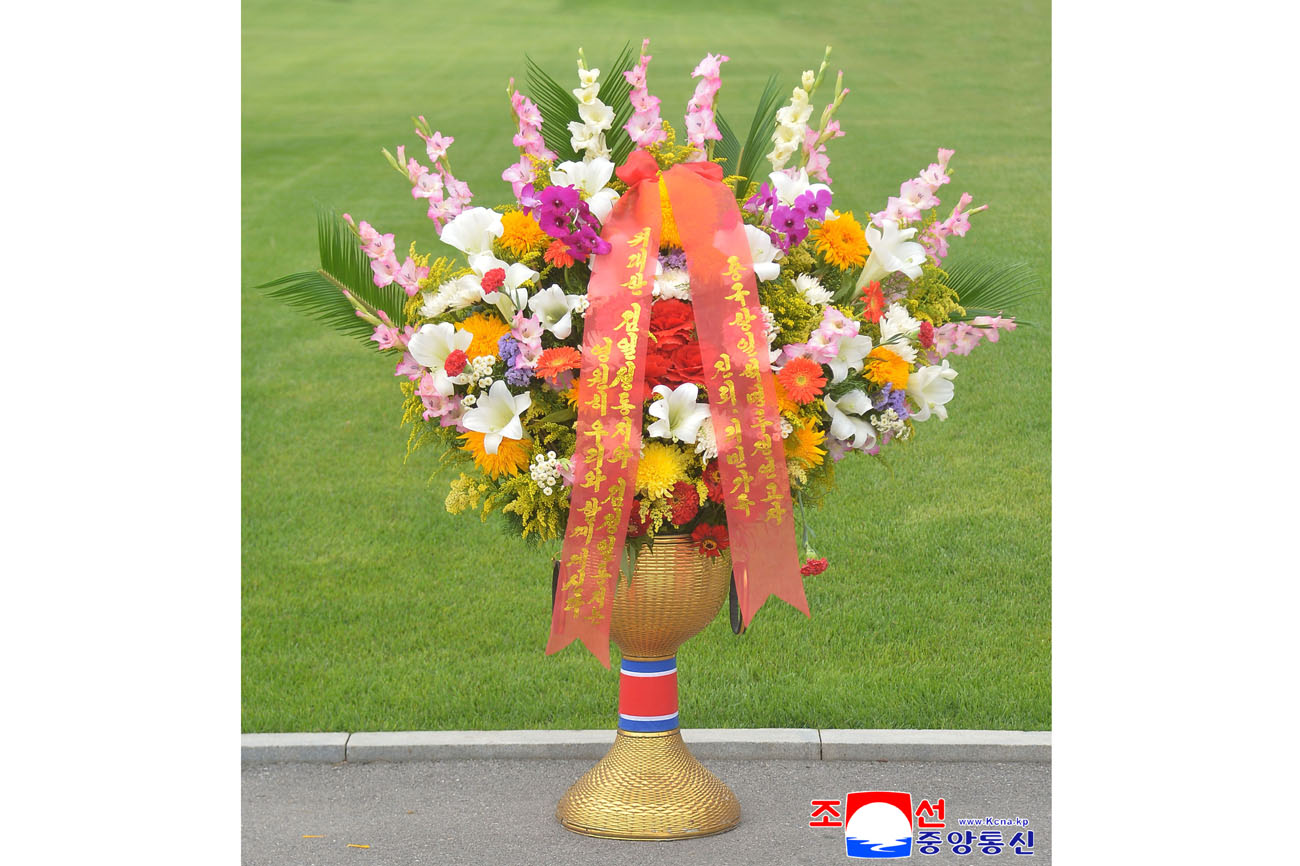 Floral baskets sent to bronze statues of great leaders Kim Il Sung and Kim Jong Il