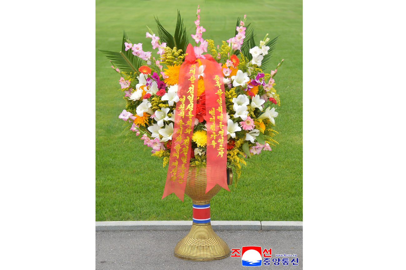 Floral baskets sent to bronze statues of great leaders Kim Il Sung and Kim Jong Il