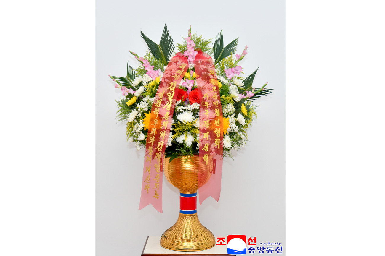 Floral baskets sent to bronze statues of great leaders Kim Il Sung and Kim Jong Il