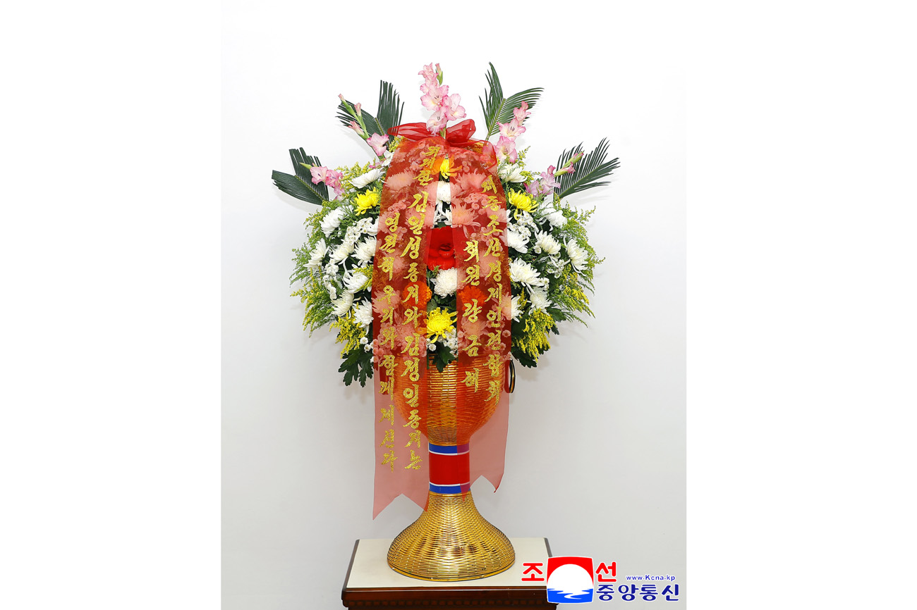 Floral baskets sent to bronze statues of great leaders Kim Il Sung and Kim Jong Il