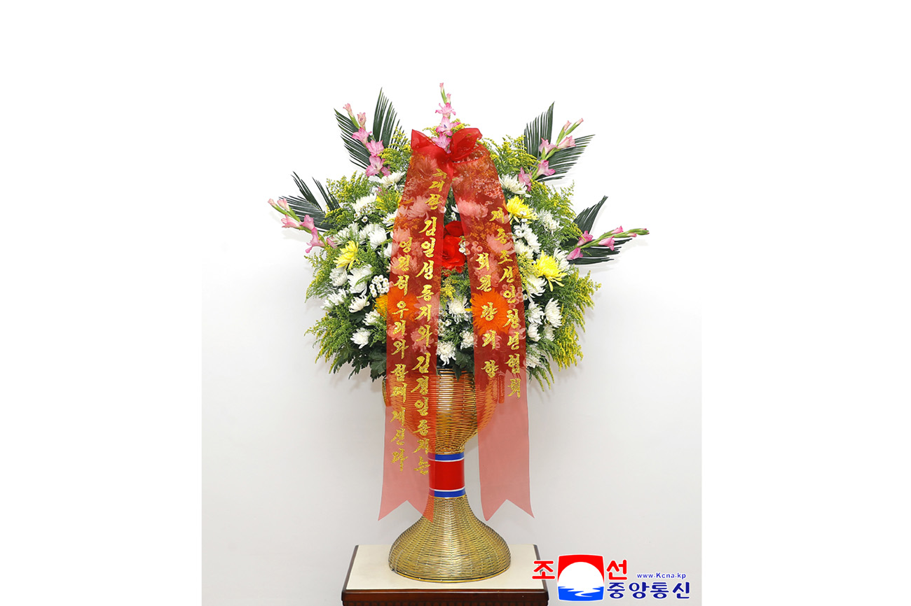 Floral baskets sent to bronze statues of great leaders Kim Il Sung and Kim Jong Il