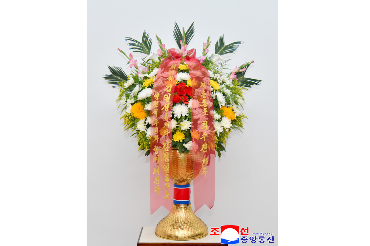 Floral baskets sent to bronze statues of great leaders Kim Il Sung and Kim Jong Il