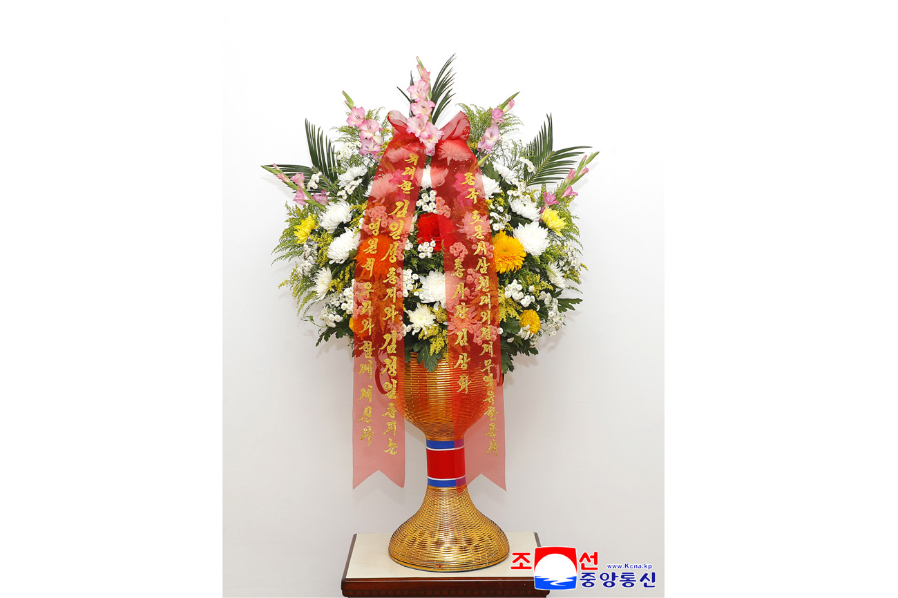 Floral baskets sent to bronze statues of great leaders Kim Il Sung and Kim Jong Il