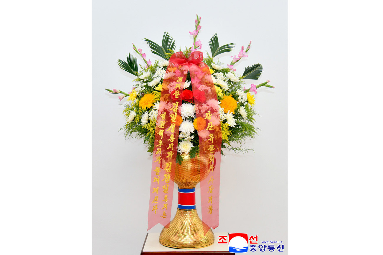 Floral baskets sent to bronze statues of great leaders Kim Il Sung and Kim Jong Il
