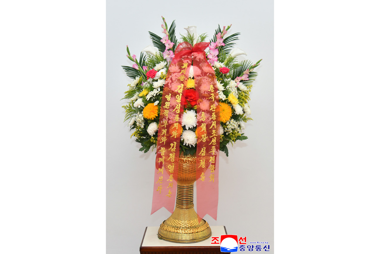 Floral baskets sent to bronze statues of great leaders Kim Il Sung and Kim Jong Il