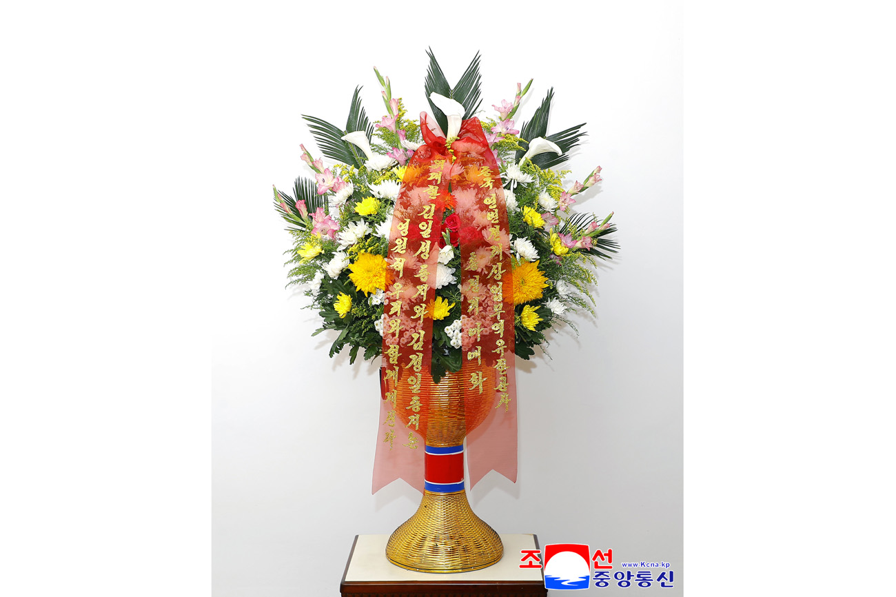 Floral baskets sent to bronze statues of great leaders Kim Il Sung and Kim Jong Il