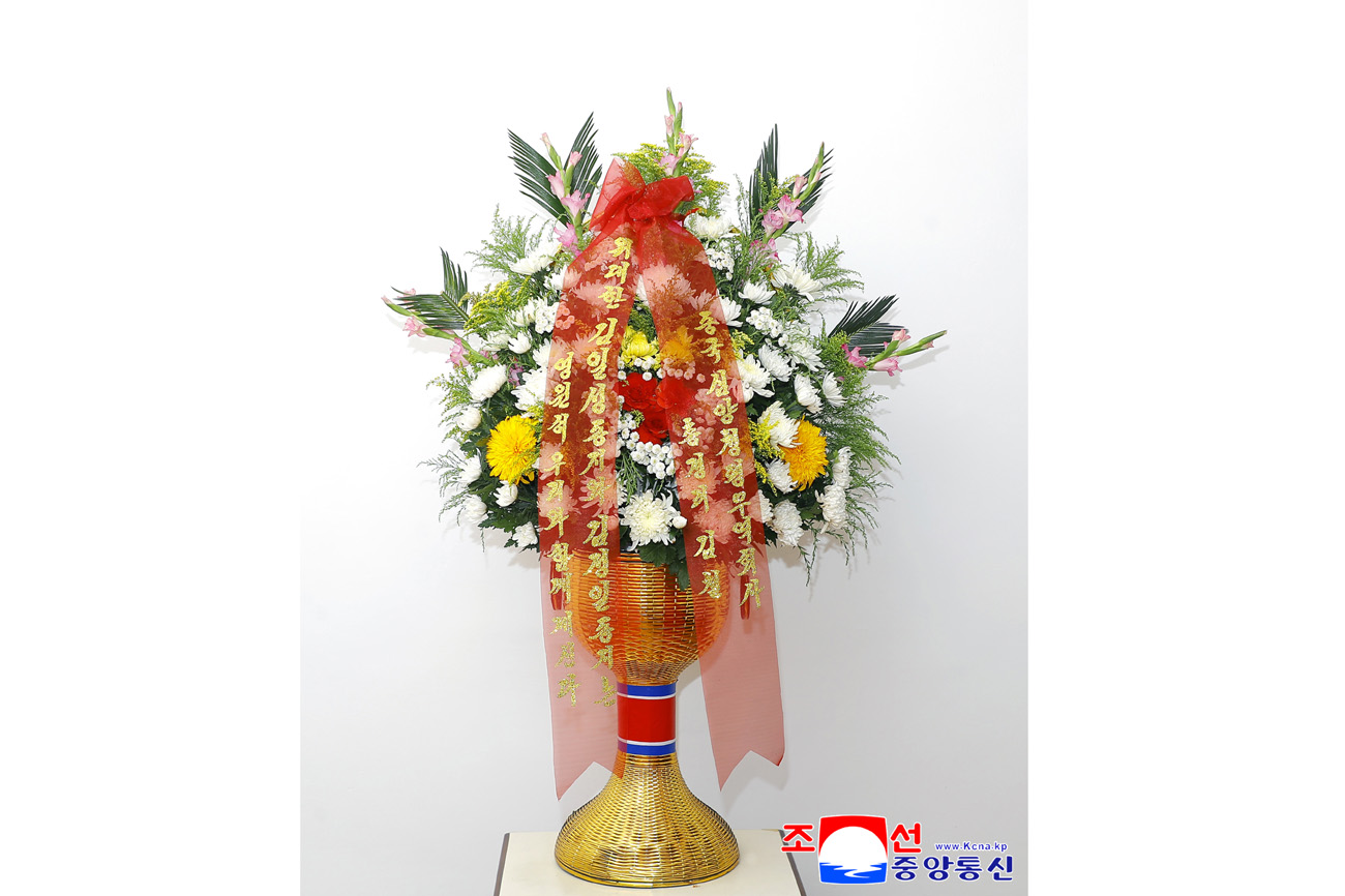 Floral baskets sent to bronze statues of great leaders Kim Il Sung and Kim Jong Il
