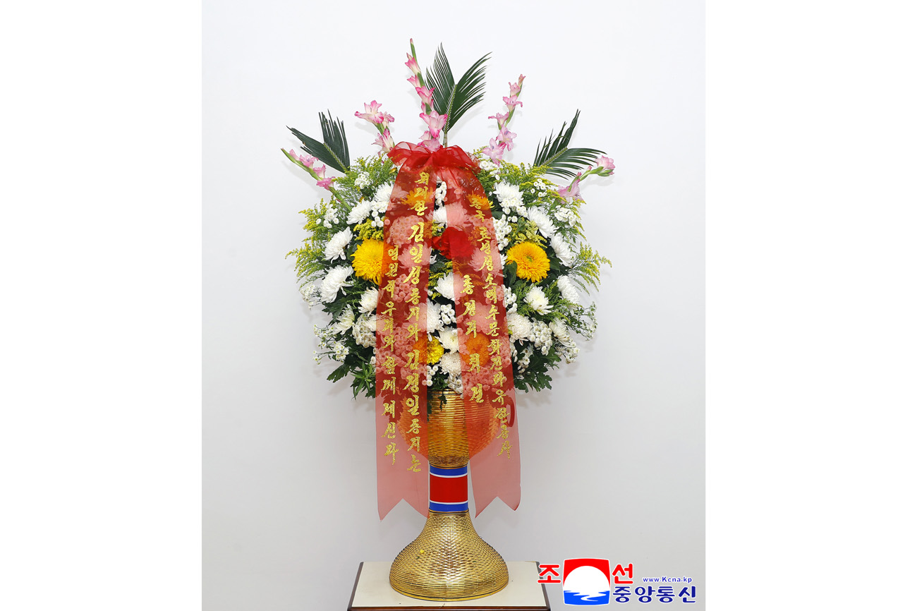 Floral baskets sent to bronze statues of great leaders Kim Il Sung and Kim Jong Il
