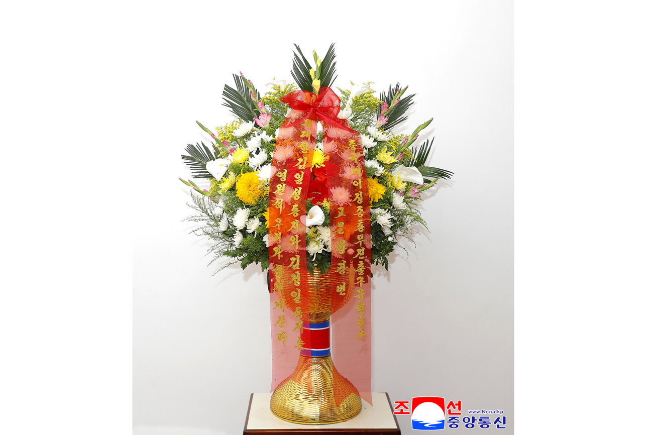 Floral baskets sent to bronze statues of great leaders Kim Il Sung and Kim Jong Il