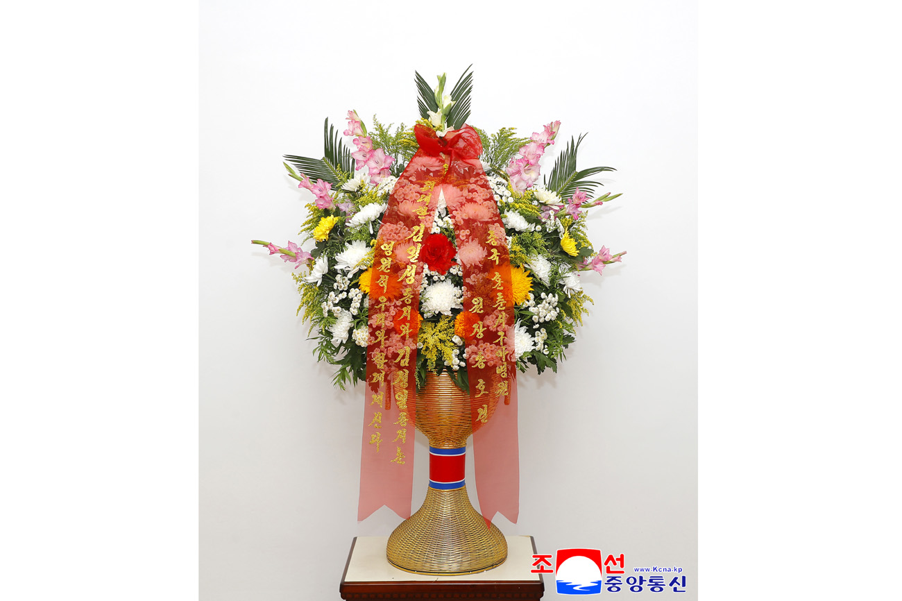 Floral baskets sent to bronze statues of great leaders Kim Il Sung and Kim Jong Il