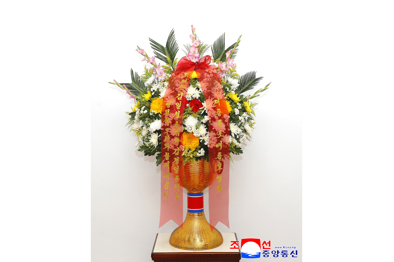 Floral baskets sent to bronze statues of great leaders Kim Il Sung and Kim Jong Il
