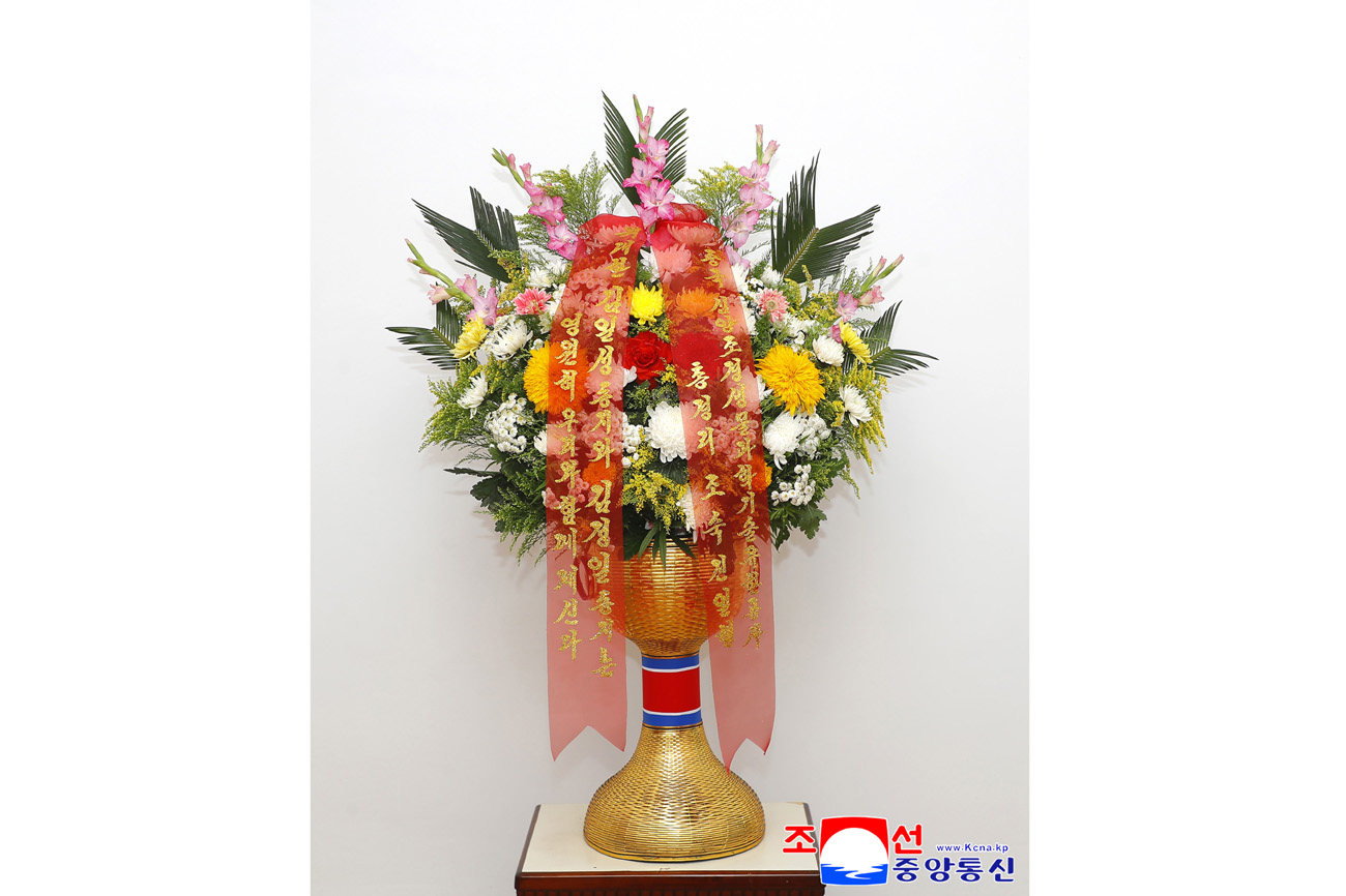 Floral baskets sent to bronze statues of great leaders Kim Il Sung and Kim Jong Il