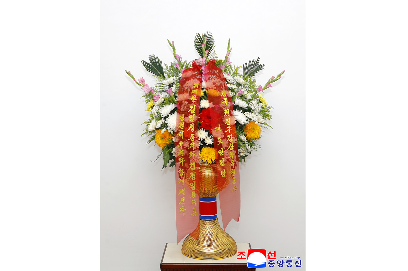 Floral baskets sent to bronze statues of great leaders Kim Il Sung and Kim Jong Il