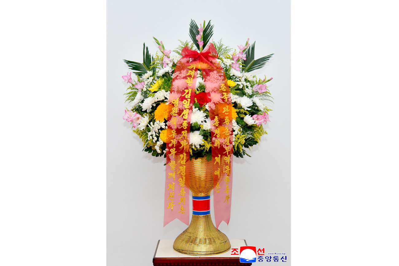 Floral baskets sent to bronze statues of great leaders Kim Il Sung and Kim Jong Il