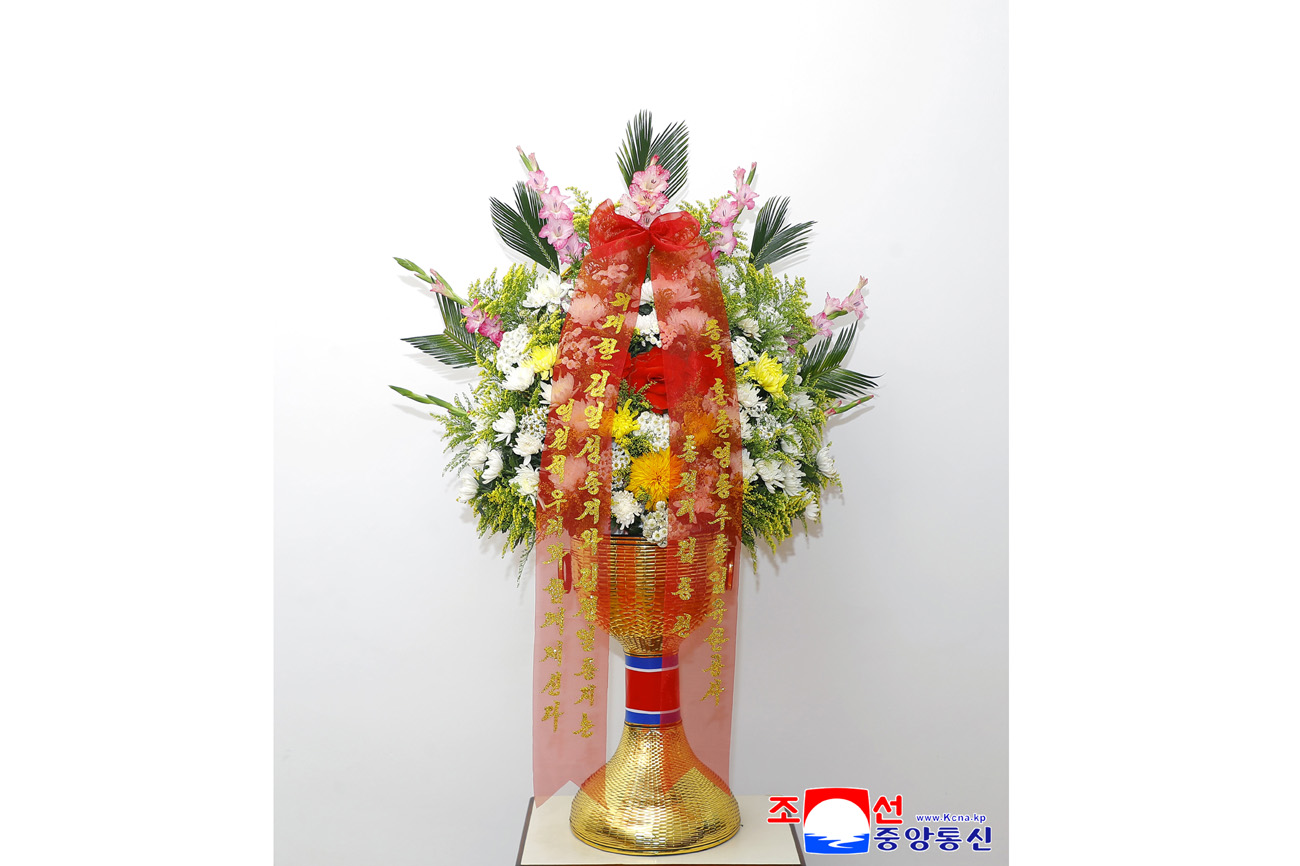 Floral baskets sent to bronze statues of great leaders Kim Il Sung and Kim Jong Il