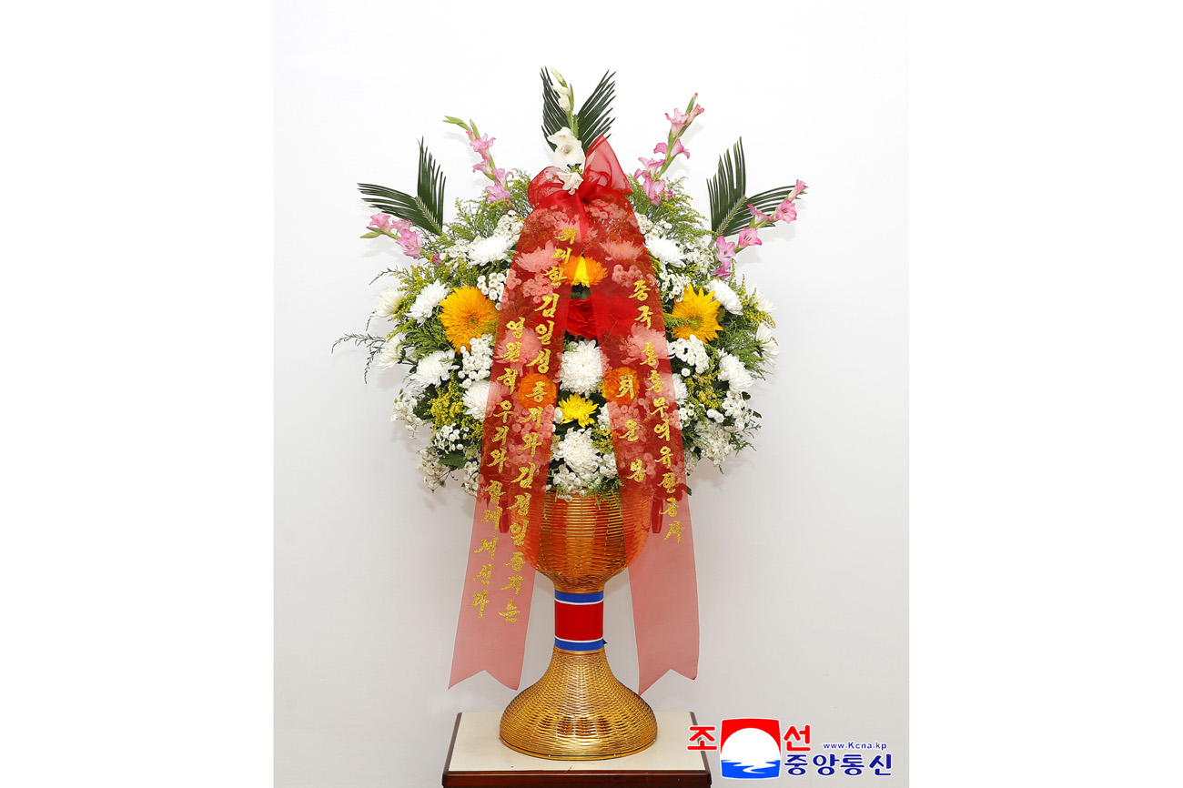Floral baskets sent to bronze statues of great leaders Kim Il Sung and Kim Jong Il