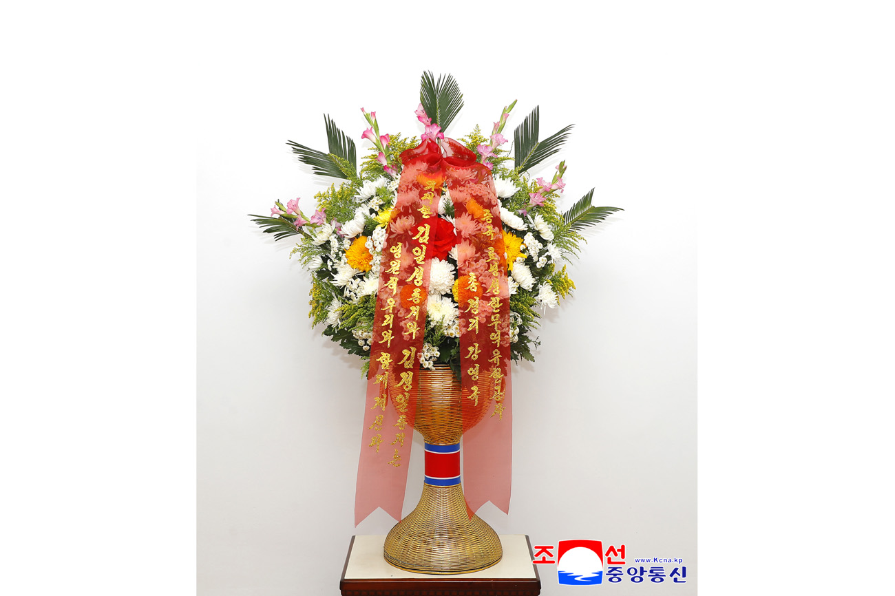 Floral baskets sent to bronze statues of great leaders Kim Il Sung and Kim Jong Il