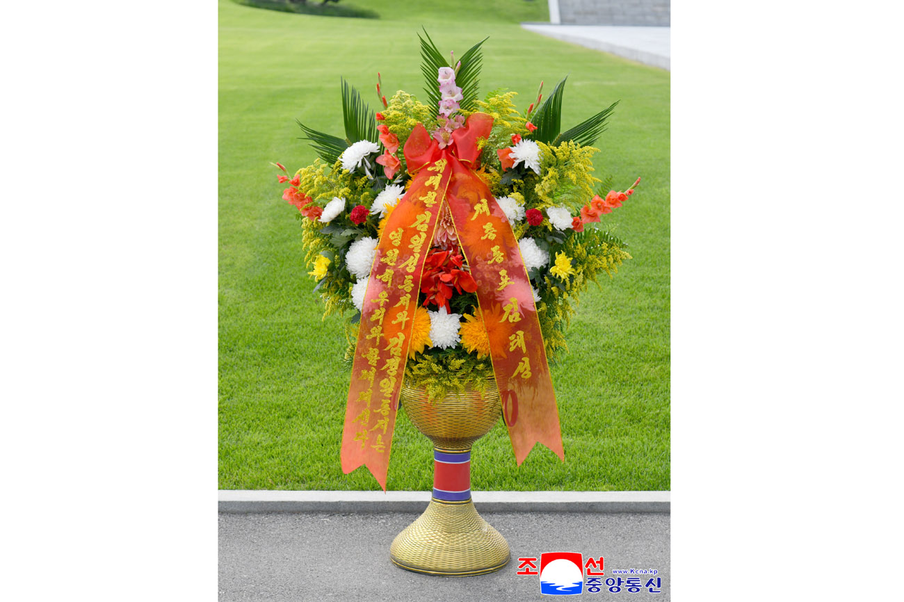 Floral baskets sent to bronze statues of great leaders Kim Il Sung and Kim Jong Il