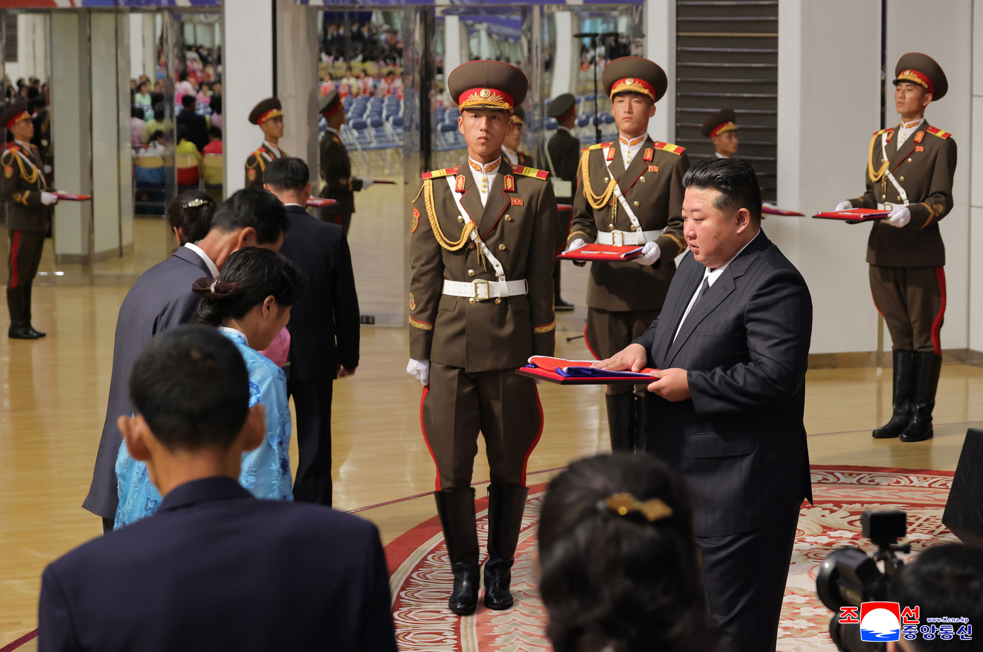 Respected Comrade Kim Jong Un meets bereaved families of martyrs who rendered distinguished services in overseas military operations to console and have photo session with them