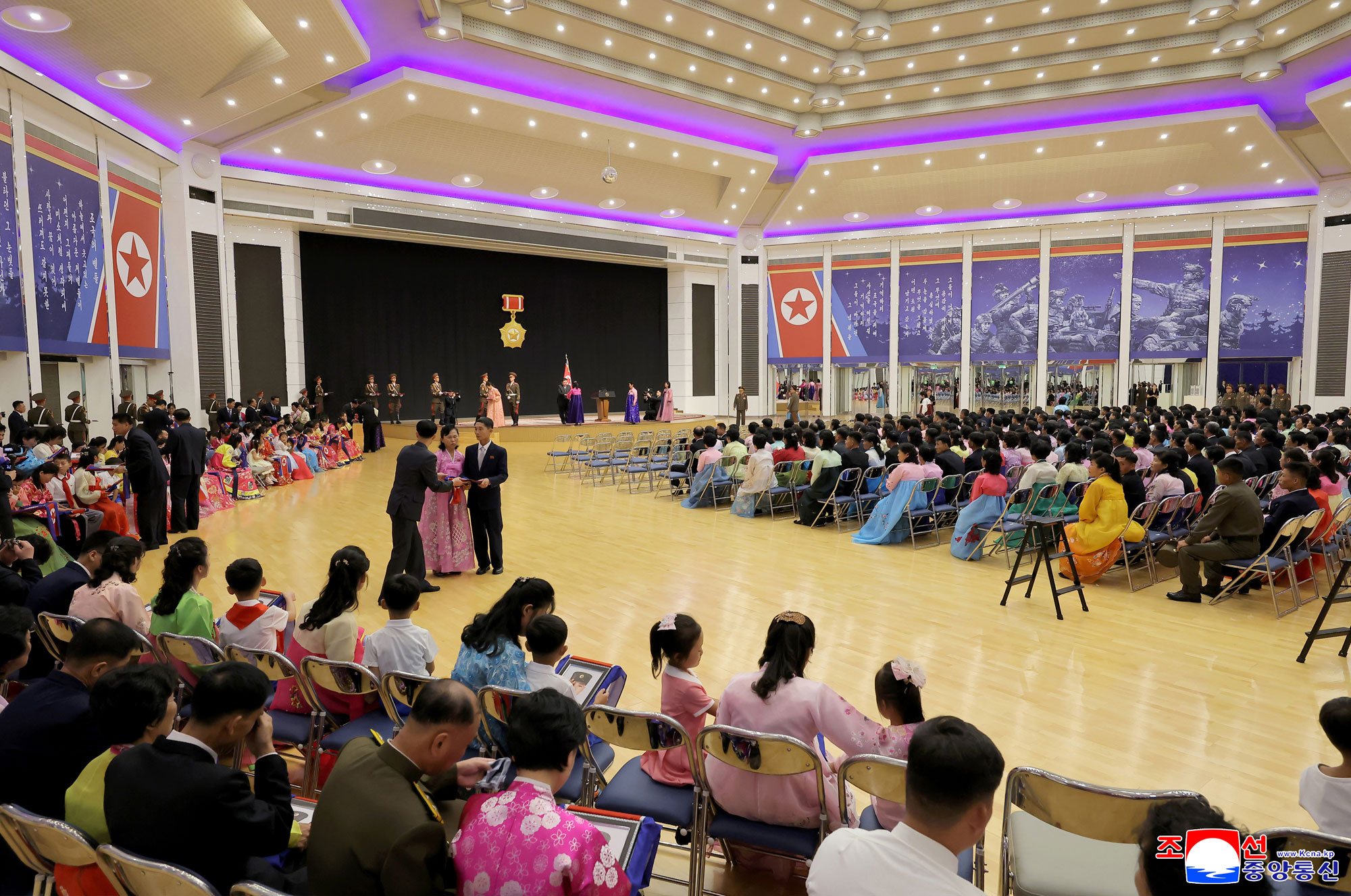 Respected Comrade Kim Jong Un meets bereaved families of martyrs who rendered distinguished services in overseas military operations to console and have photo session with them