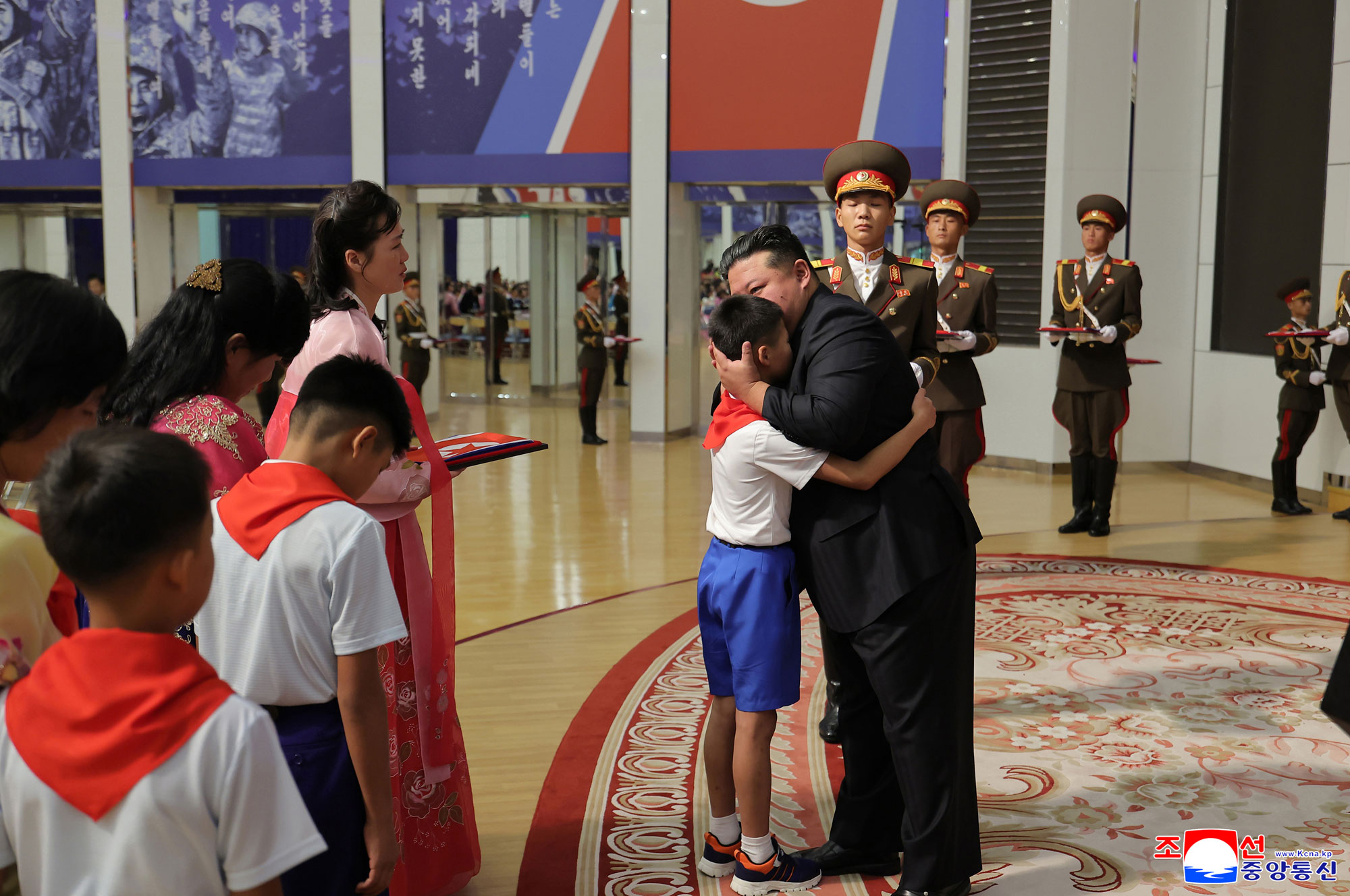 Respected Comrade Kim Jong Un meets bereaved families of martyrs who rendered distinguished services in overseas military operations to console and have photo session with them