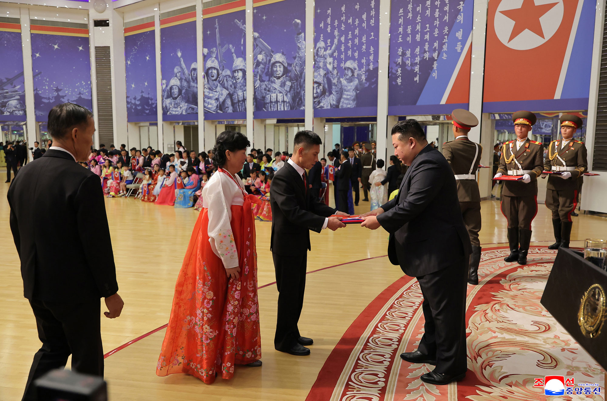 Respected Comrade Kim Jong Un meets bereaved families of martyrs who rendered distinguished services in overseas military operations to console and have photo session with them