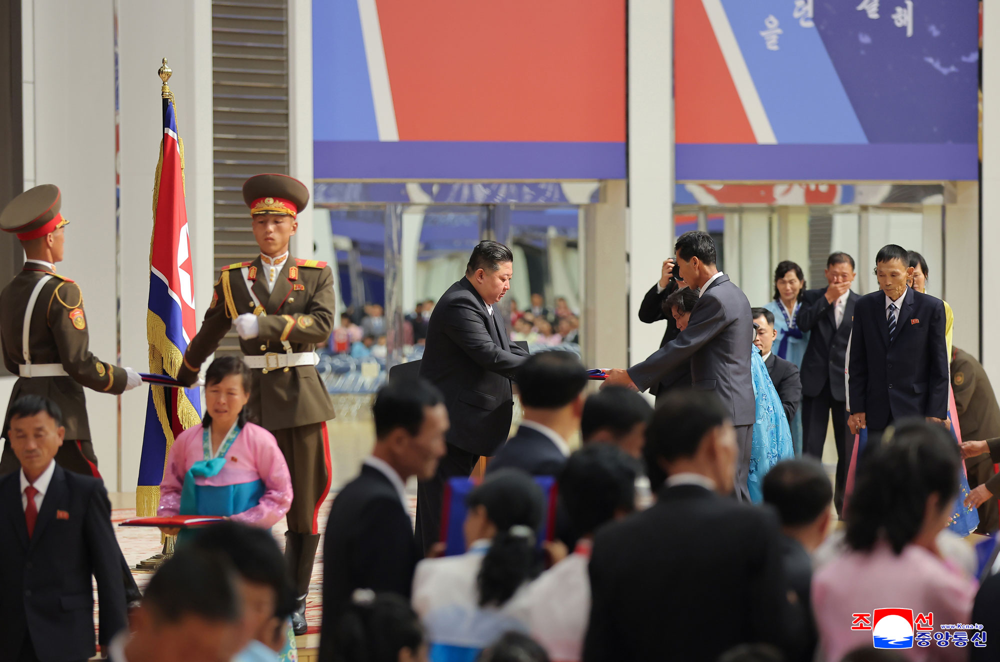 Respected Comrade Kim Jong Un meets bereaved families of martyrs who rendered distinguished services in overseas military operations to console and have photo session with them