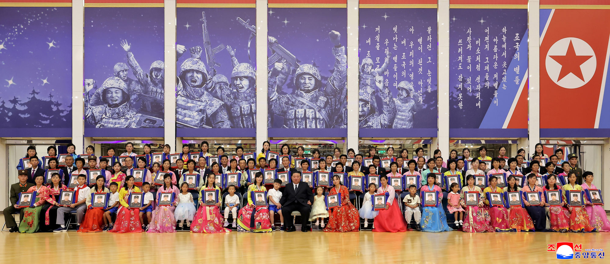 Respected Comrade Kim Jong Un meets bereaved families of martyrs who rendered distinguished services in overseas military operations to console and have photo session with them
