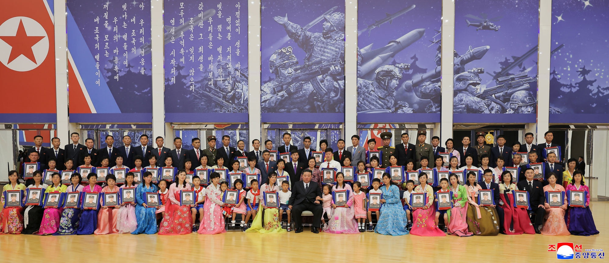 Respected Comrade Kim Jong Un meets bereaved families of martyrs who rendered distinguished services in overseas military operations to console and have photo session with them