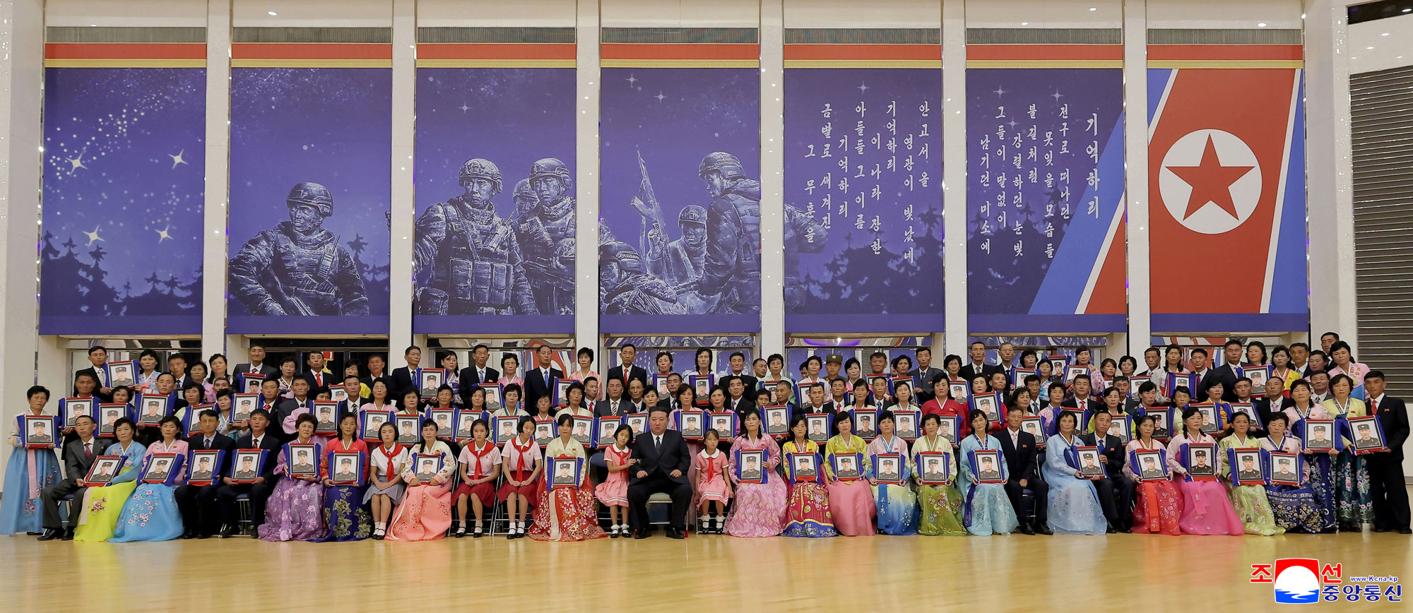 Respected Comrade Kim Jong Un meets bereaved families of martyrs who rendered distinguished services in overseas military operations to console and have photo session with them