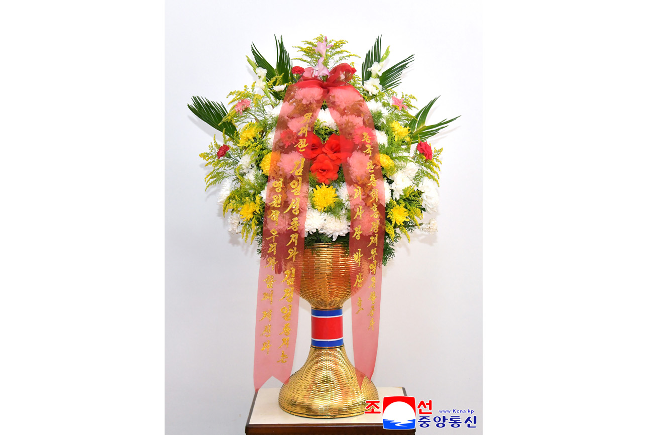 Floral baskets sent to bronze statues of great leaders Kim Il Sung and Kim Jong Il by Koreans in China
