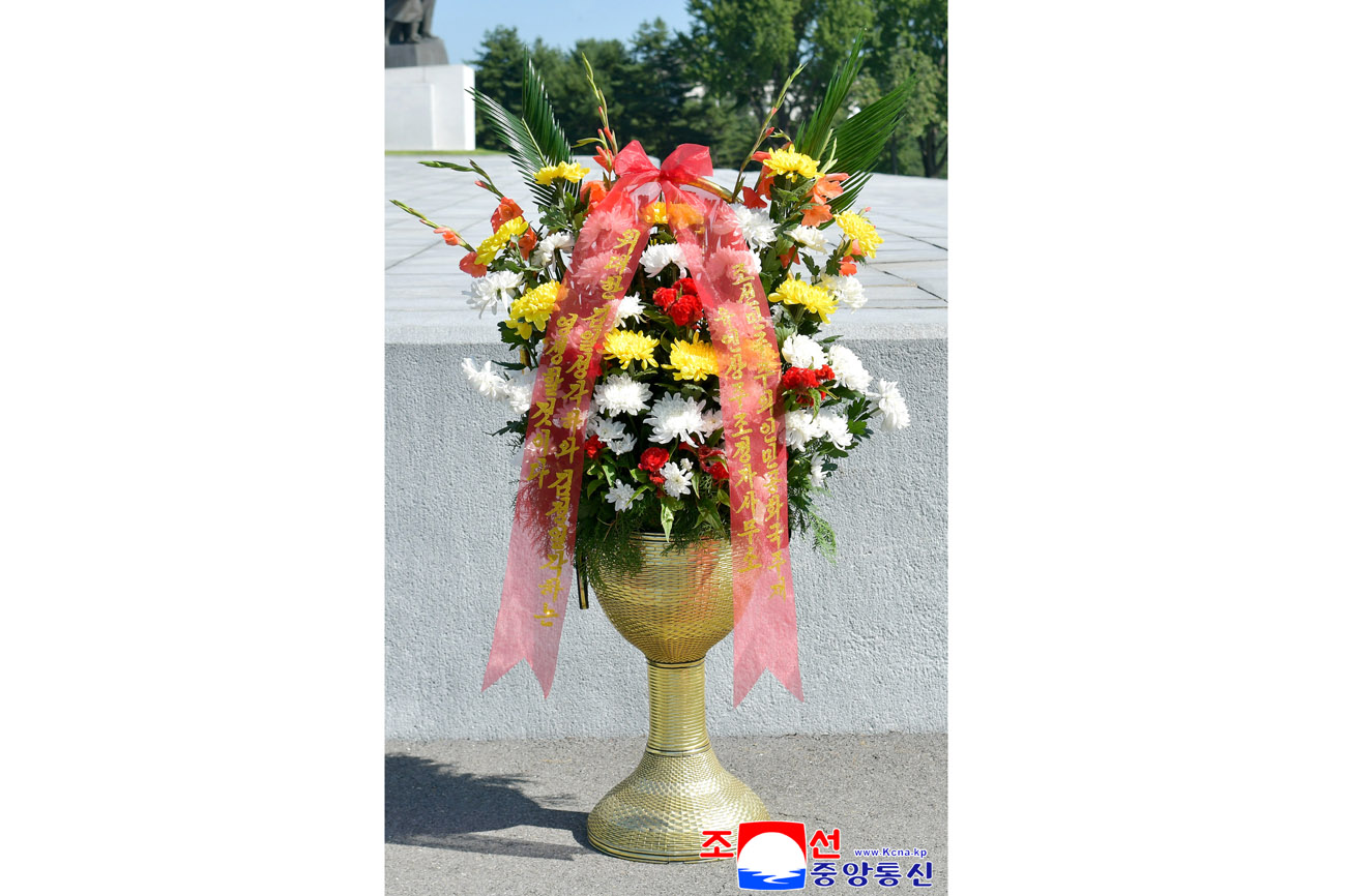 Floral baskets sent to bronze statues of great leaders Kim Il Sung and Kim Jong Il by Koreans in China