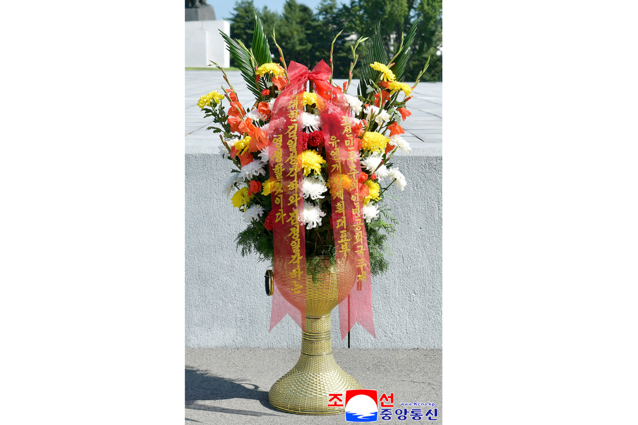 Floral baskets sent to bronze statues of great leaders Kim Il Sung and Kim Jong Il by Koreans in China