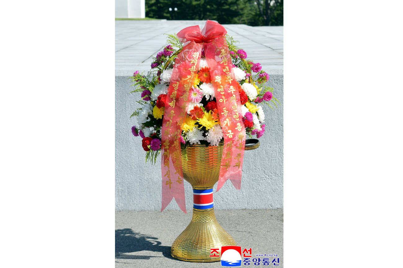 Floral baskets sent to bronze statues of great leaders Kim Il Sung and Kim Jong Il by Koreans in China